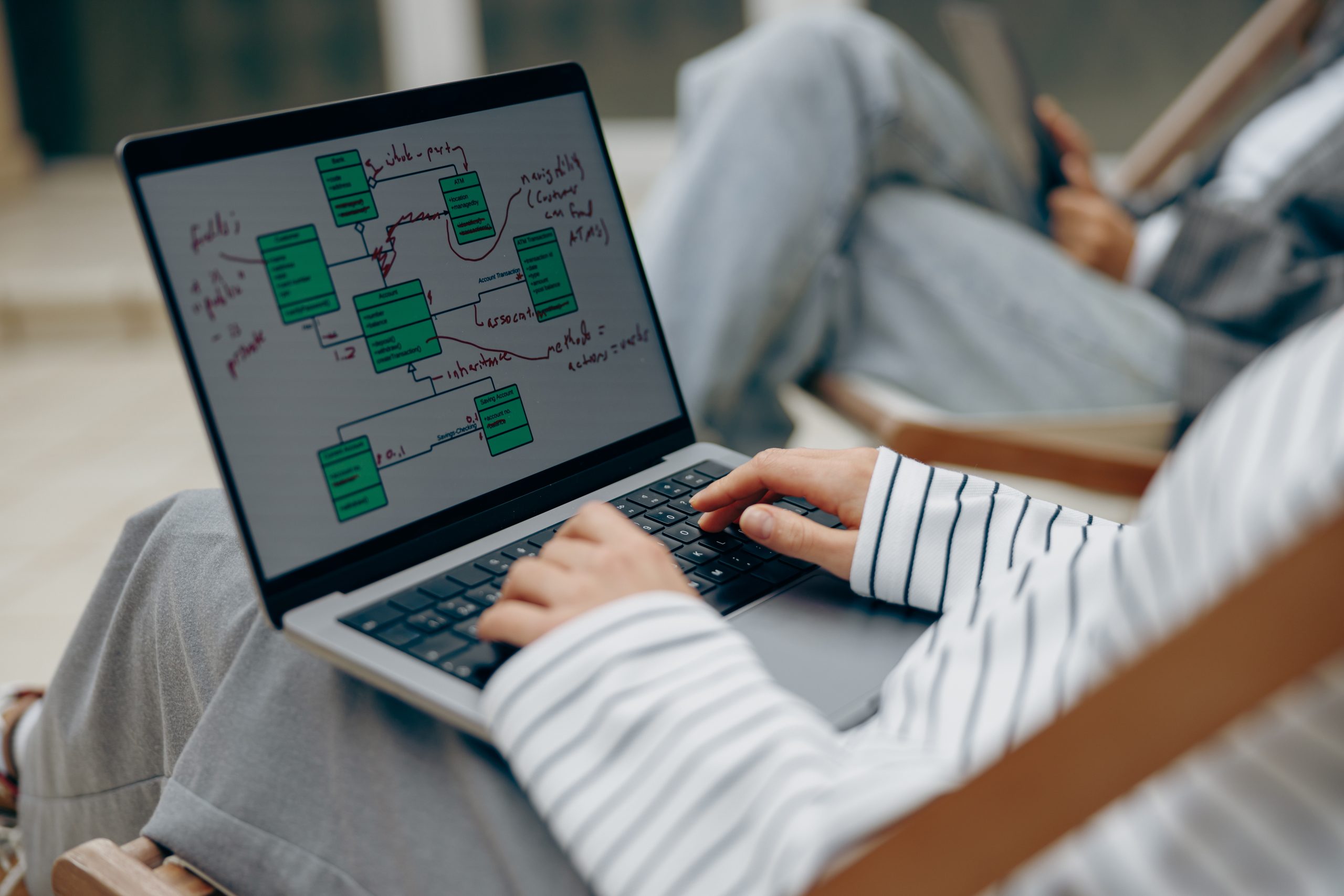 Woman viewing a database diagram on a laptop, symbolizing OcalaCode.com's custom database design and development services.