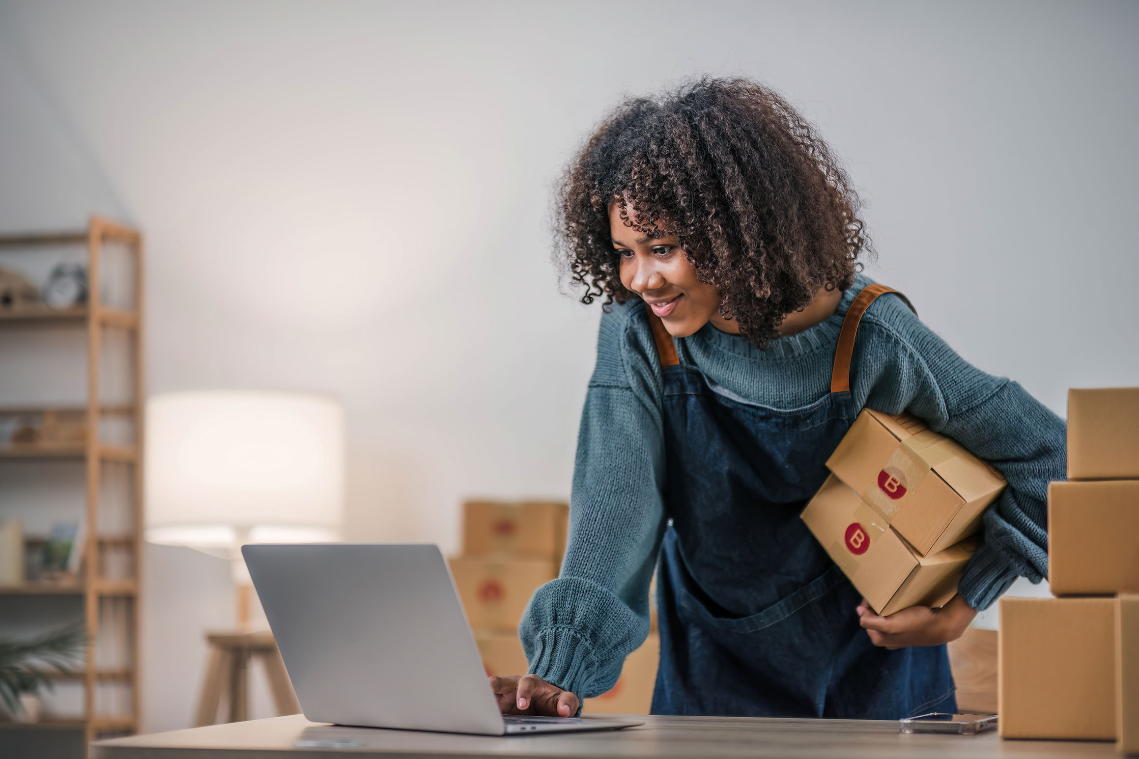 Woman making an online purchase on a laptop, symbolizing secure eCommerce transactions and a smooth shopping experience.