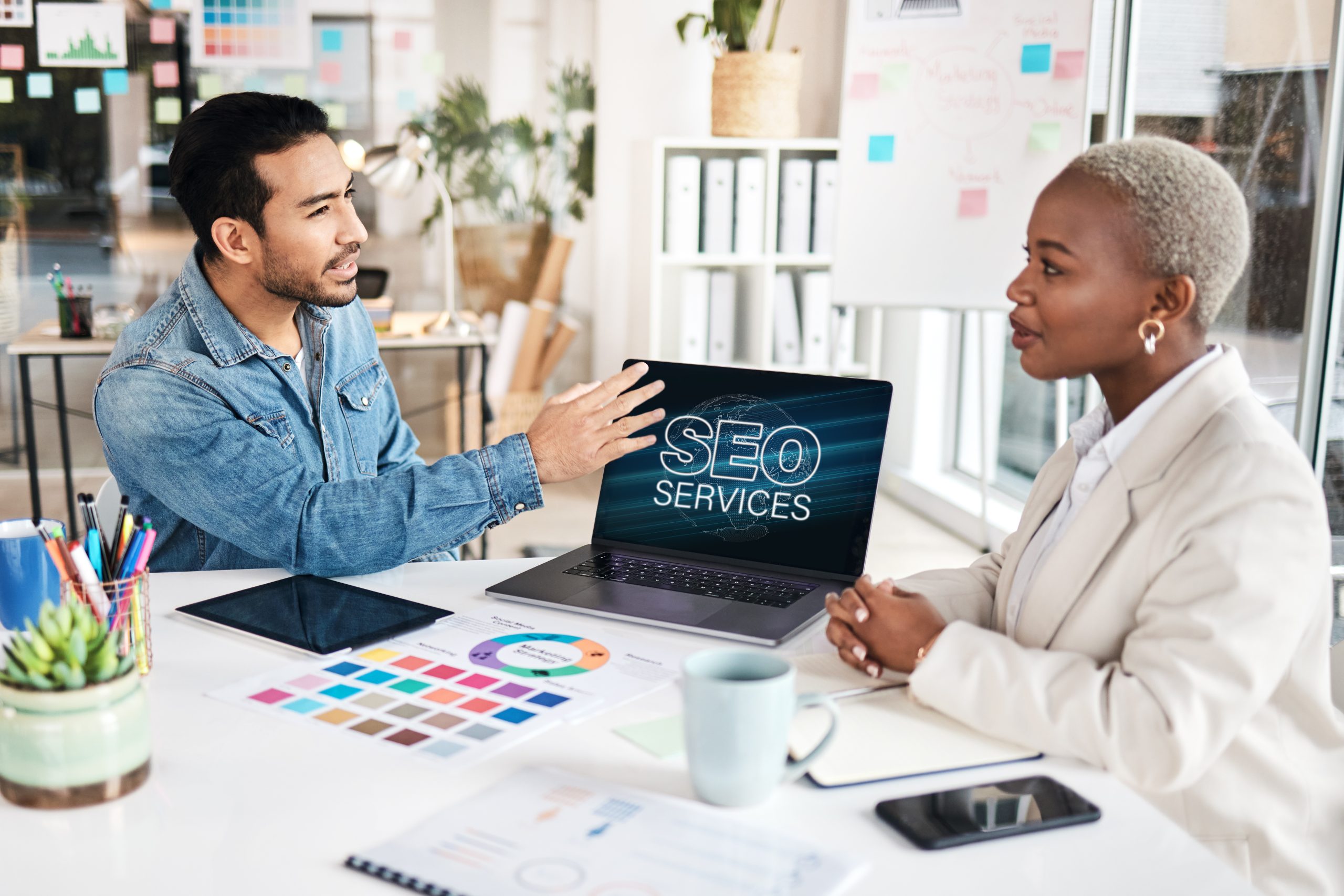 Man and woman discussing SEO services from OcalaCode.com, symbolizing collaboration for better search engine optimization strategies.